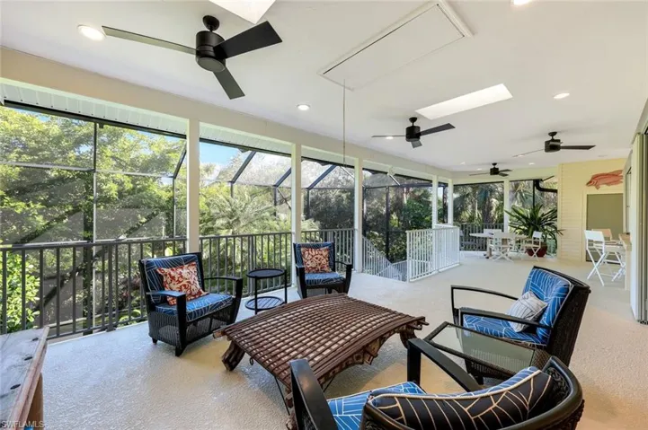 Living room opens to a large screened in porch featuring MORE sky lights and yet another space for entertaining!