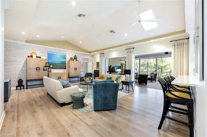 Imagine relaxing riverside in this great room featuring vaulted ceilings and stunning views!