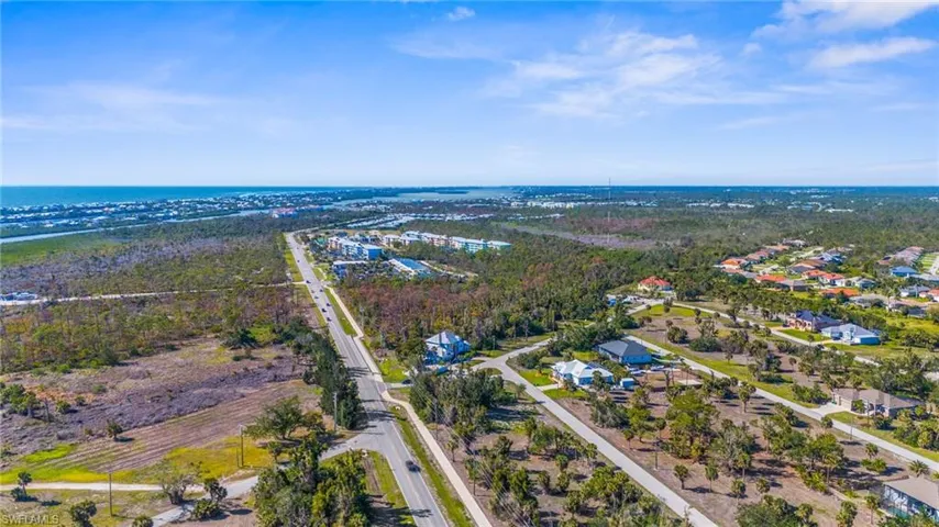 Aerial view of residential area featuring a nearby body of water