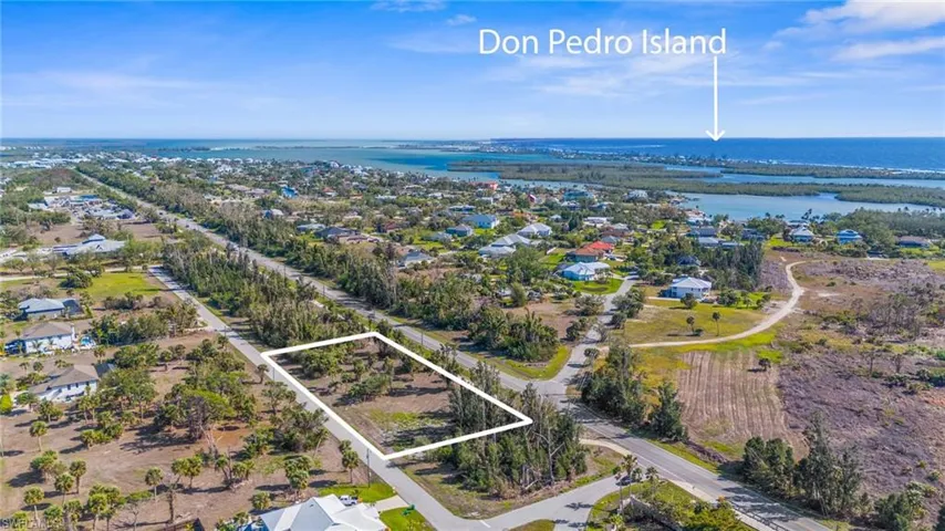 Aerial perspective of suburban area featuring a large body of water and property parcel outlined