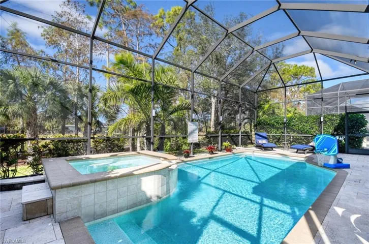View of pool with a lanai, an in ground hot tub, and a patio
