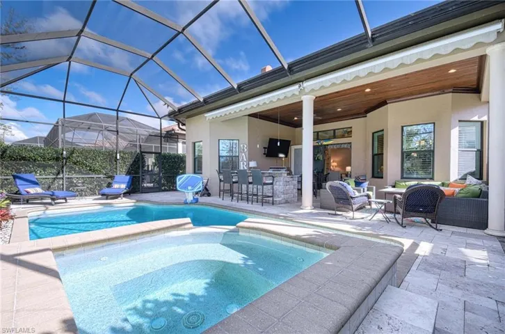 View of swimming pool featuring an outdoor living space, an outdoor bar, and an in ground hot tub