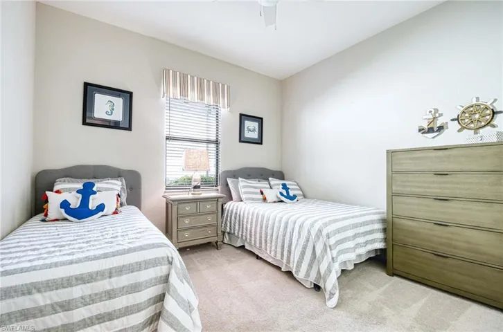 Bedroom featuring ceiling fan and light colored carpet