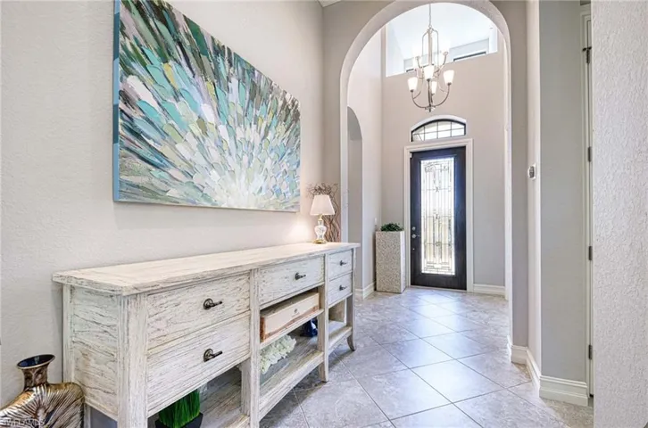 Tiled entrance foyer with a chandelier