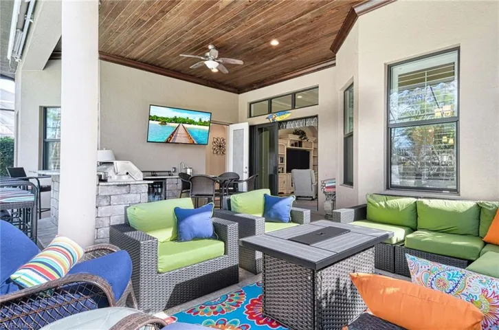 View of patio / terrace featuring a grill, ceiling fan, and an outdoor kitchen,