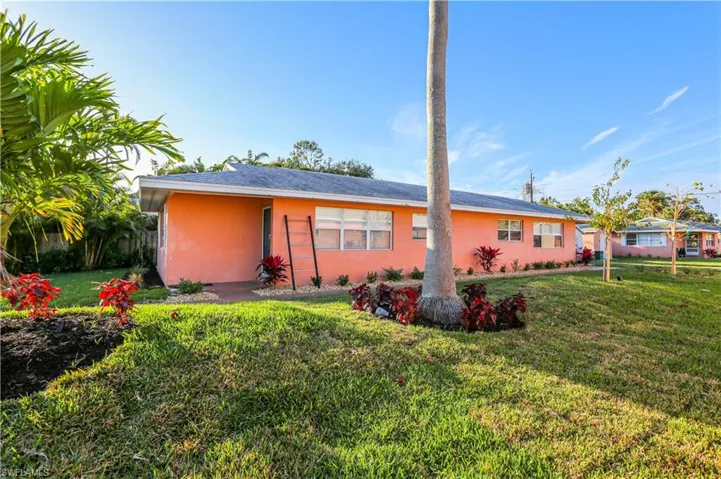 Rear view of house with a yard