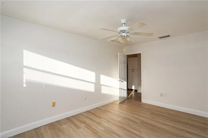 Unfurnished room featuring light hardwood / wood-style floors and ceiling fan