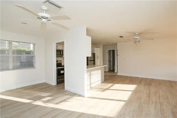 Spare room featuring ceiling fan and light hardwood / wood-style floors