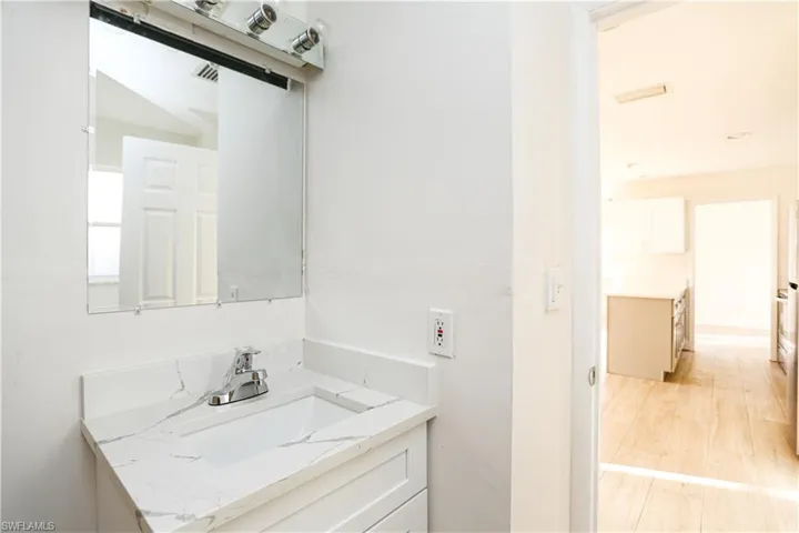 Bathroom featuring hardwood / wood-style flooring and vanity