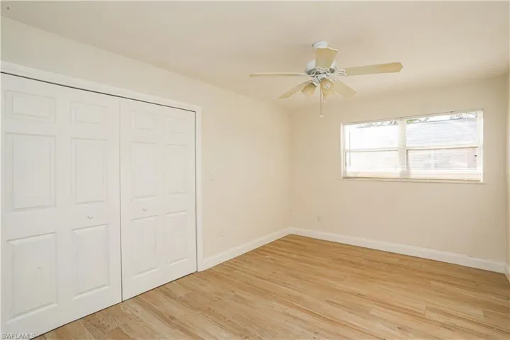 Unfurnished bedroom featuring light hardwood / wood-style floors, ceiling fan, and a closet