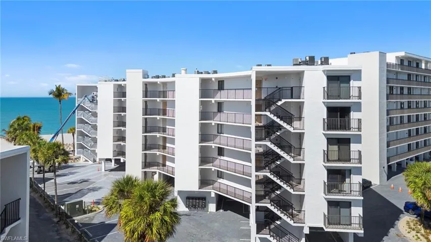 View of apartment building / complex featuring a water view