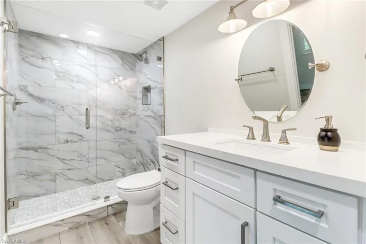 Second primary bathroom featuring a walk-in shower