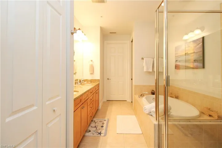 Bathroom featuring vanity, independent shower and bath, and tile patterned flooring