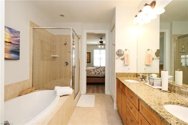 Bathroom with vanity, separate shower and tub, and tile patterned flooring