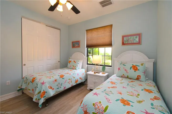 Bedroom featuring a closet, light wood-type flooring, and ceiling fan