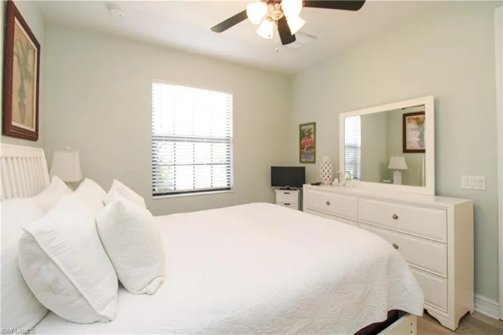 Bedroom featuring ceiling fan and light hardwood / wood-style flooring