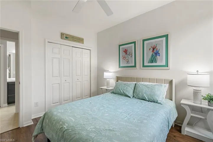 Bedroom featuring a closet, a ceiling fan, and dark wood-type flooring
