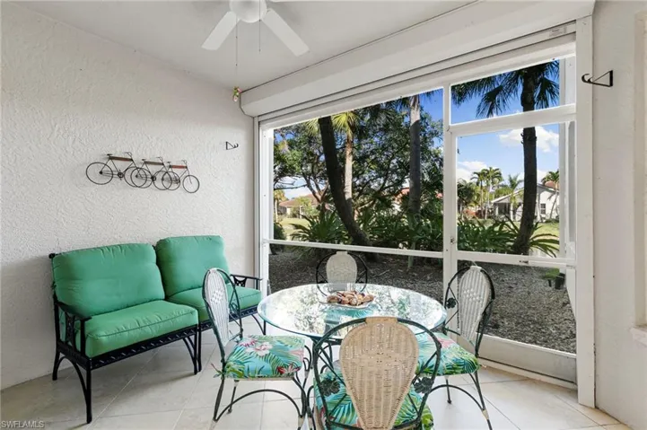 Sunroom with ceiling fan and outdoor dining space