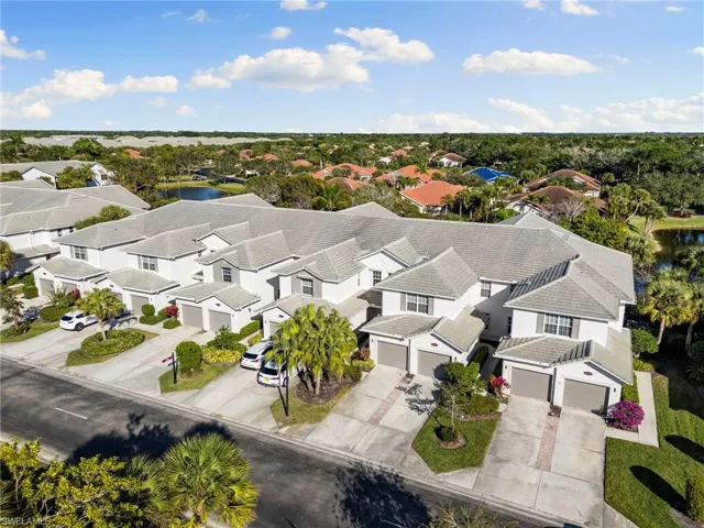 Aerial perspective of suburban area with a nearby body of water