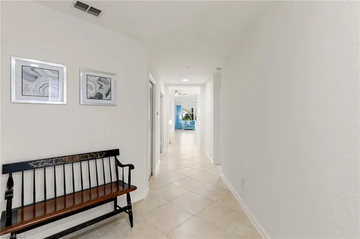 Hallway featuring light tile patterned flooring and recessed lighting