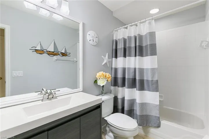 Full bathroom featuring vanity and shower / bath combo with shower curtain