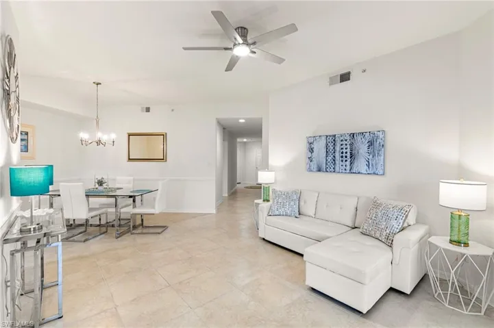 Living area with a ceiling fan and hanging lights