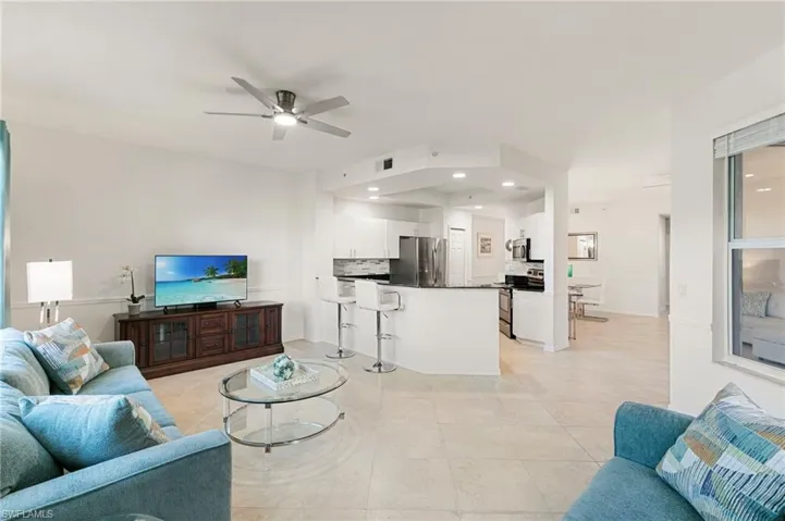 Living room featuring ceiling fan, light tile patterned floors, and recessed lighting