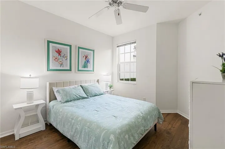 Bedroom featuring dark wood-type flooring and ceiling fan