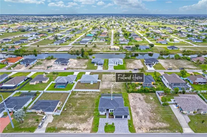 Aerial perspective of suburban area with a nearby body of water