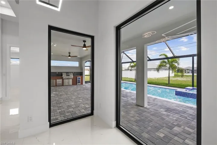 View of pool featuring a pool with connected hot tub and ceiling fan