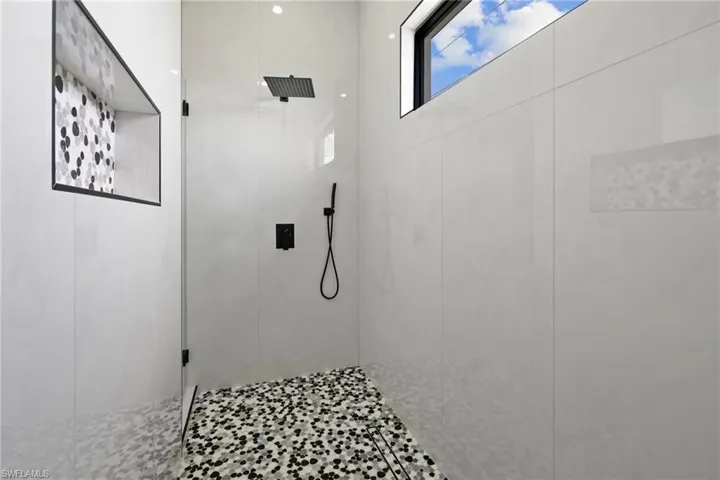 Full bath featuring tiled shower