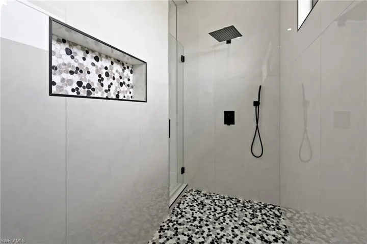 Full bath featuring a tile shower