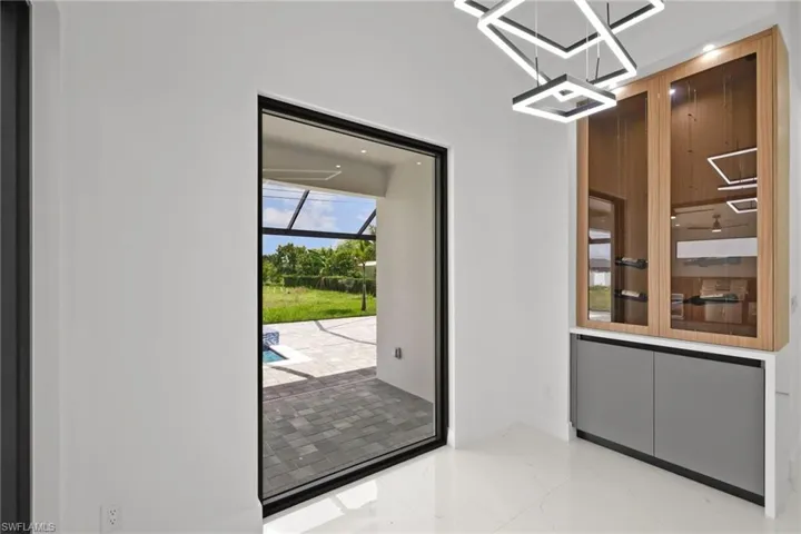 Doorway to outside featuring marble tiled flooring