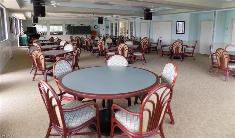 Carpeted dining room featuring ceiling fan