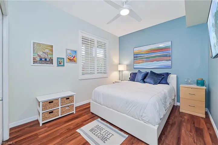 Bedroom featuring dark hardwood / wood-style floors and ceiling fan