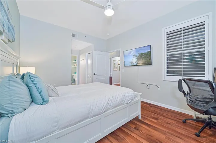 Bedroom with hardwood / wood-style flooring and ceiling fan