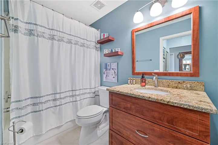 Bathroom with tile patterned floors, vanity, and toilet