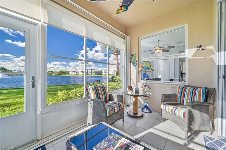 Sunroom with a water view and ceiling fan