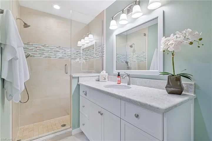 Bathroom featuring vanity and walk in shower