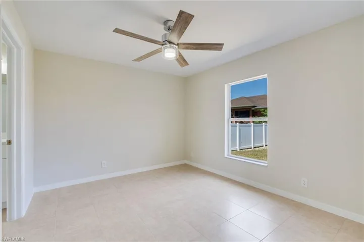 Empty room with baseboards and ceiling fan