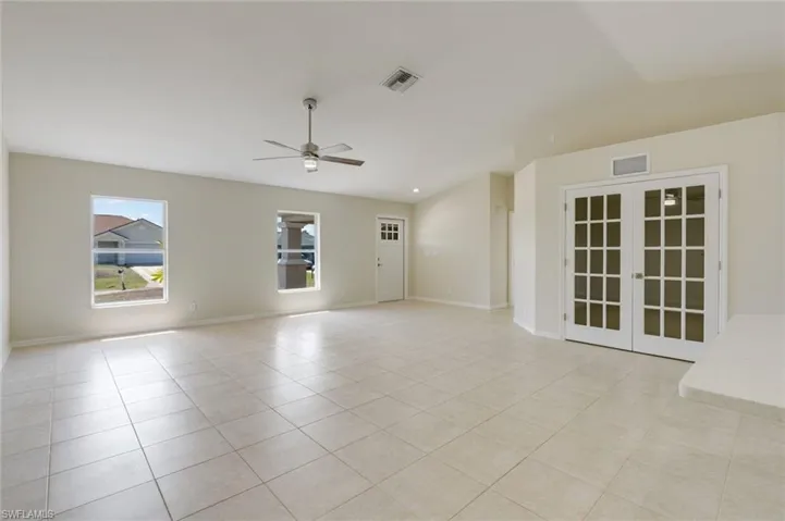 Unfurnished room with french doors, a ceiling fan, light tile patterned floors, and recessed lighting