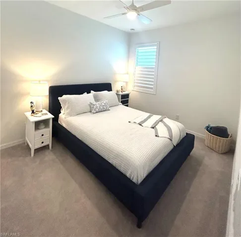 Secondary bedroom with ceiling fan & upgraded carpet