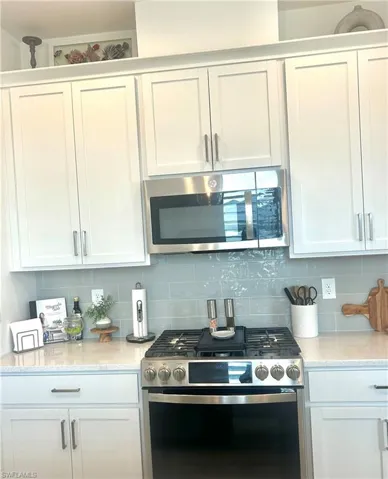 Upgrades: Chef's dream stove, tile backsplash, extended height cabinets with crown molding & hardware, counters, walk in pantry with additional outlets.