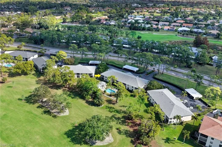 Aerial perspective of suburban area featuring a golf course