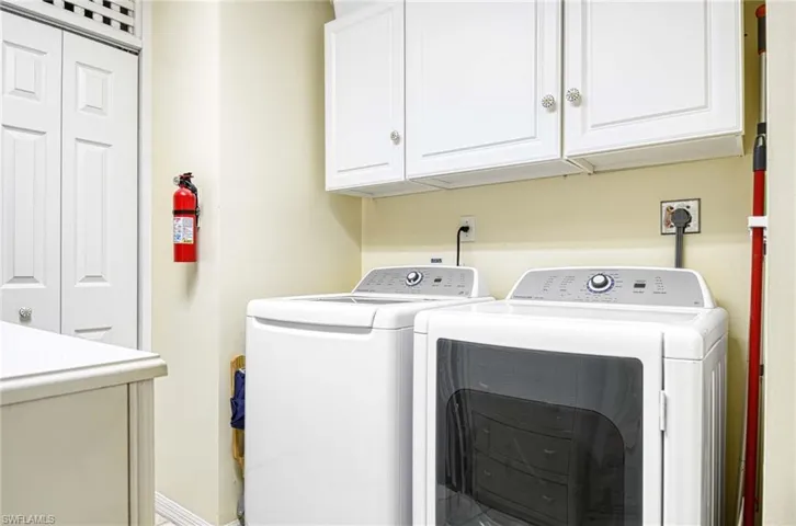 Laundry room featuring cabinet space and washer and dryer