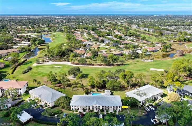 Aerial view of property and surrounding area featuring nearby suburban area