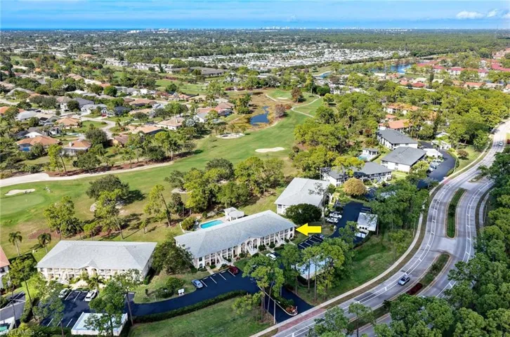 View of property location featuring a local golf course and nearby suburban area