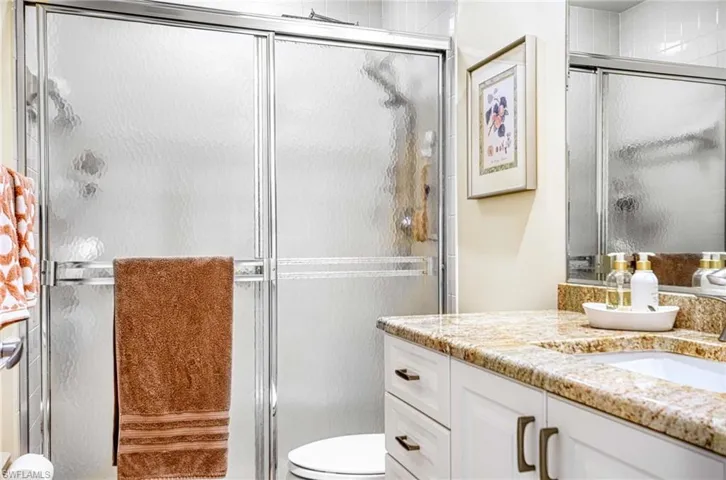 Full bath with vanity and a shower stall