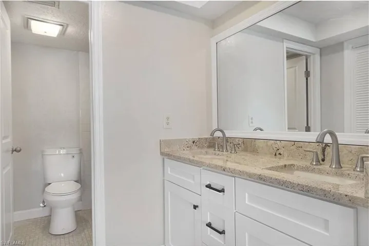 Primary Bathroom remodeling includes dual rectangular sinks, new faucets, soft close cabs & separate water closet with shower