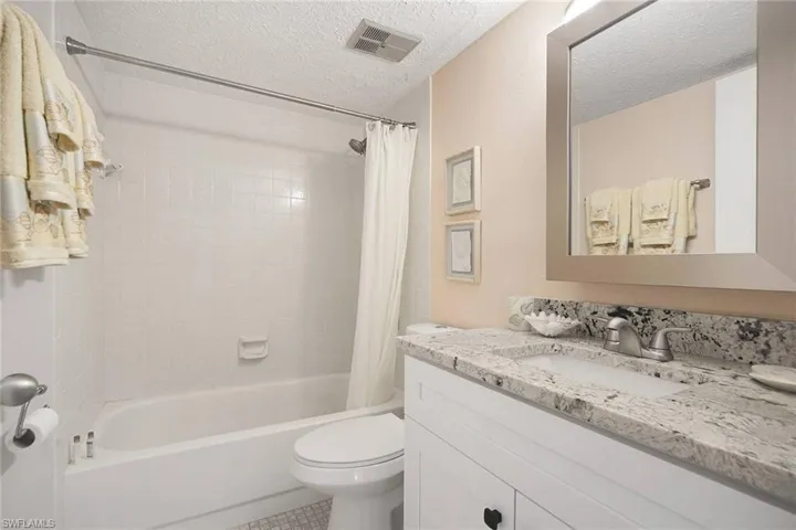 Guest Bath boasts Granite, Soft Close Cabinetry, Oversized Medicine Chest, trendy Light Fixture, etc